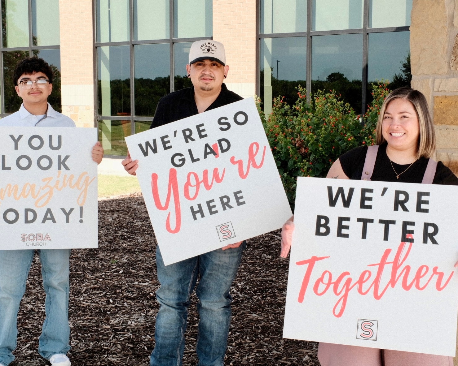 Soba Church welcome team holding signs