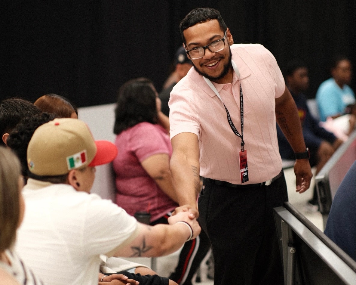 Volunteer greeting a guest